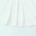 White off shoulder halter mini dress with flowy fabric detail from The Lady's Haven Boutique