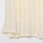 Close-up of cream-colored pleated chiffon midi skirt fabric texture and hem detail