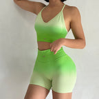 Light green two piece athletic wear set for women featuring a cropped tank top and high-waisted shorts