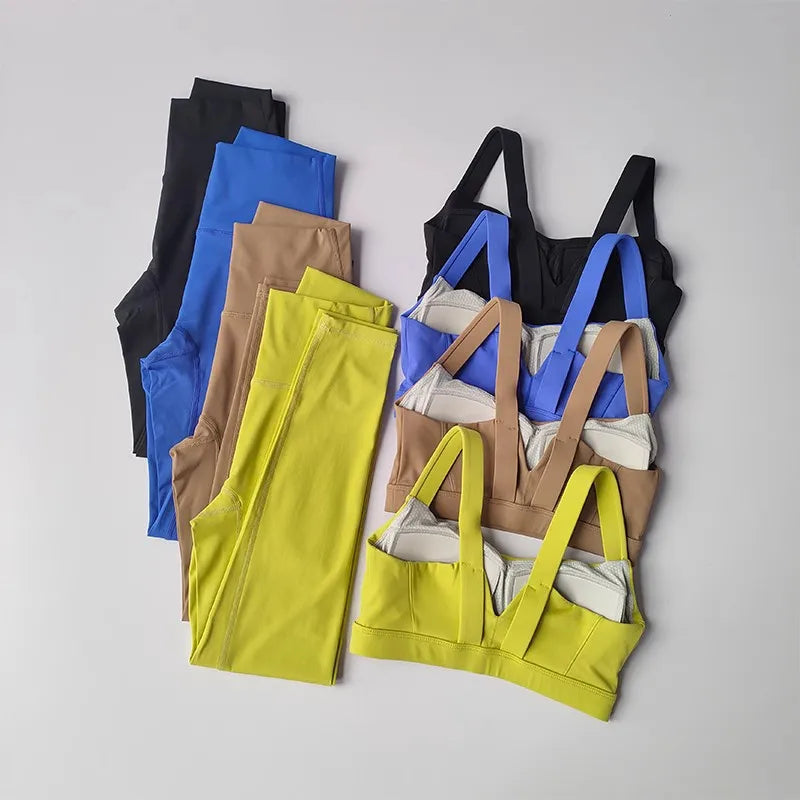 Assorted two piece workout clothing for women including bras and leggings in various colors