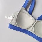 Gray and blue sports bra part of two piece workout clothing for women designed for comfort and support during exercise
