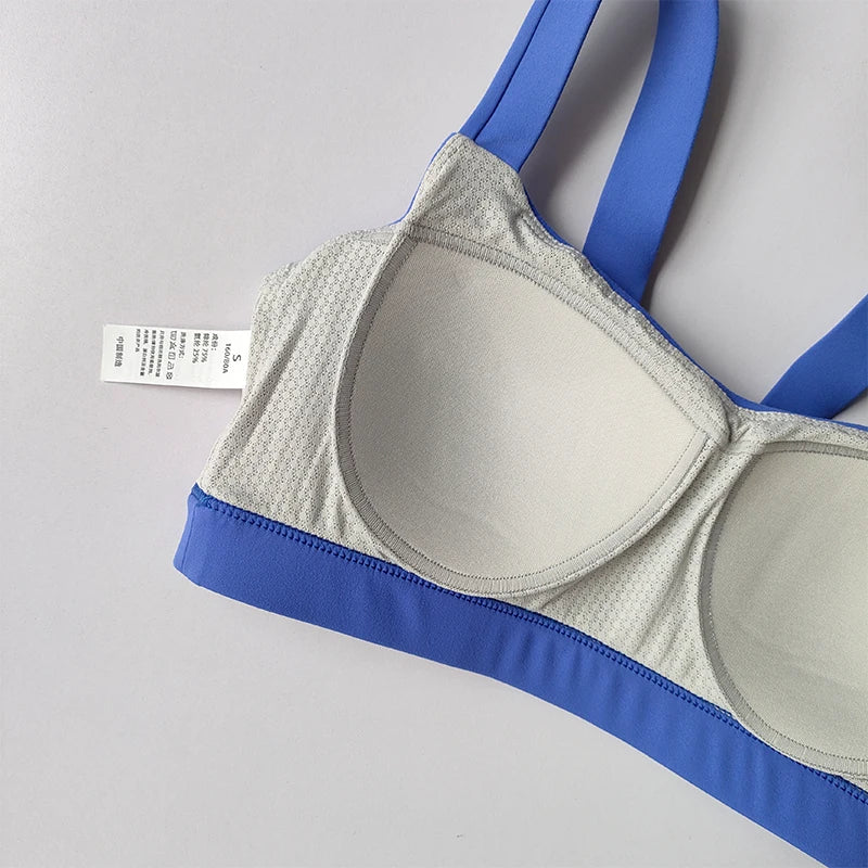 Gray and blue sports bra part of two piece workout clothing for women designed for comfort and support during exercise
