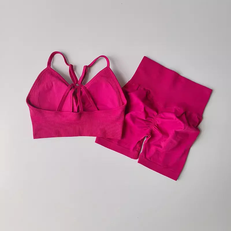 Vibrant Pink Two Piece Workout Outfits with a Strappy Crop Top and Matching High-Waisted Shorts