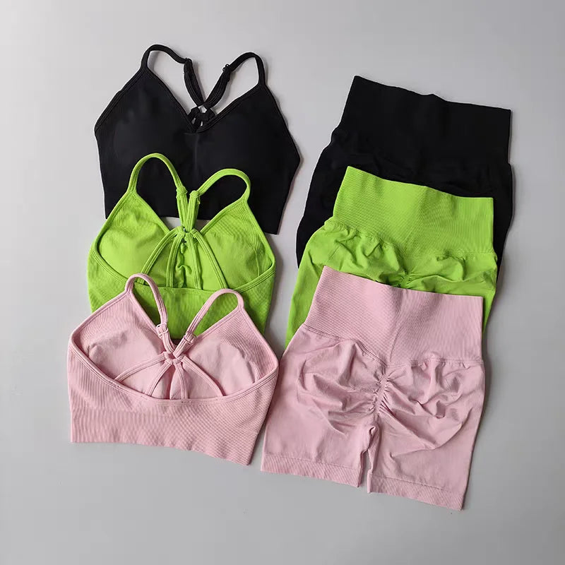 Two piece workout outfits in green, pink, and black with stylish designs for comfortable fitness wear