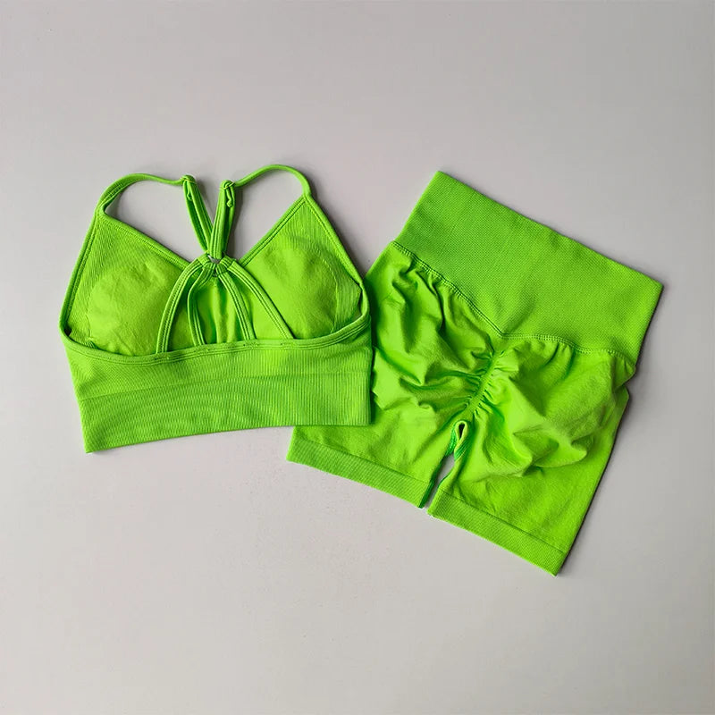 Bright green two piece workout outfits featuring a stylish crop top and a matching ruched skirt