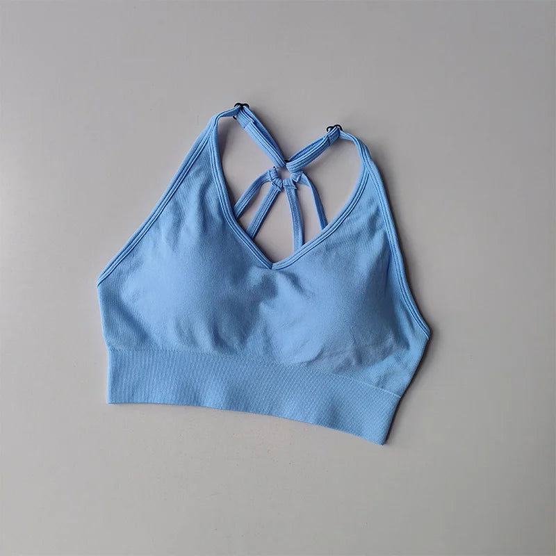 Light blue sports bra with crisscross straps, perfect for two piece workout outfits
