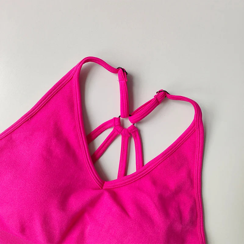 Vibrant pink crop top featuring a stylish strappy design for two piece workout outfits