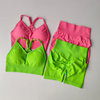 Vibrant pink and green two piece workout outfits featuring stylish crop tops and high-waisted shorts