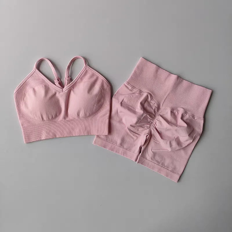 Light pink two piece workout outfits featuring a stylish sports bra and high-waisted shorts