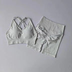 White two piece workout outfits featuring a stylish sports bra and matching high-waisted shorts