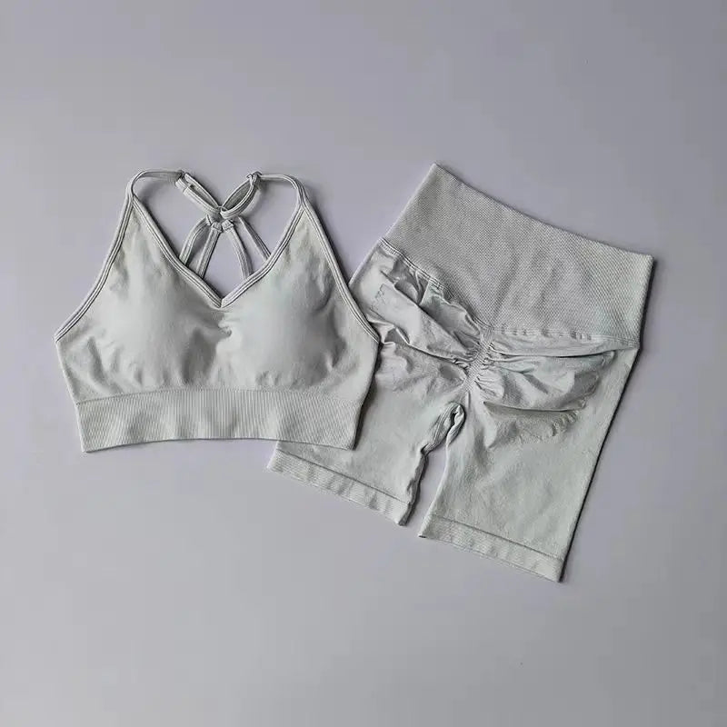 White two piece workout outfits featuring a stylish sports bra and matching high-waisted shorts