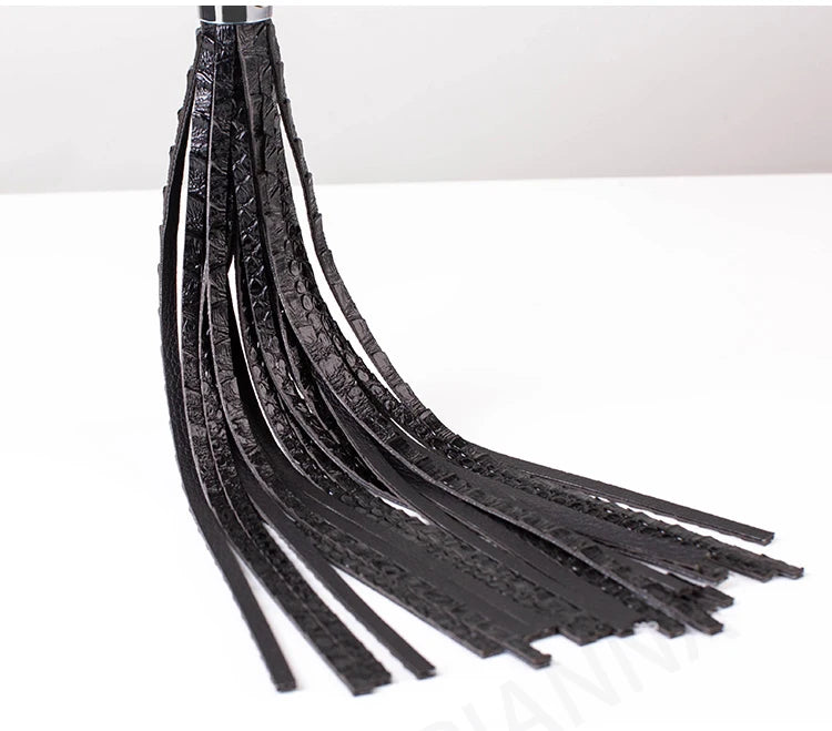 Black textured faux leather flogger with multiple thin tails for intimate play couple punishment BDSM whip