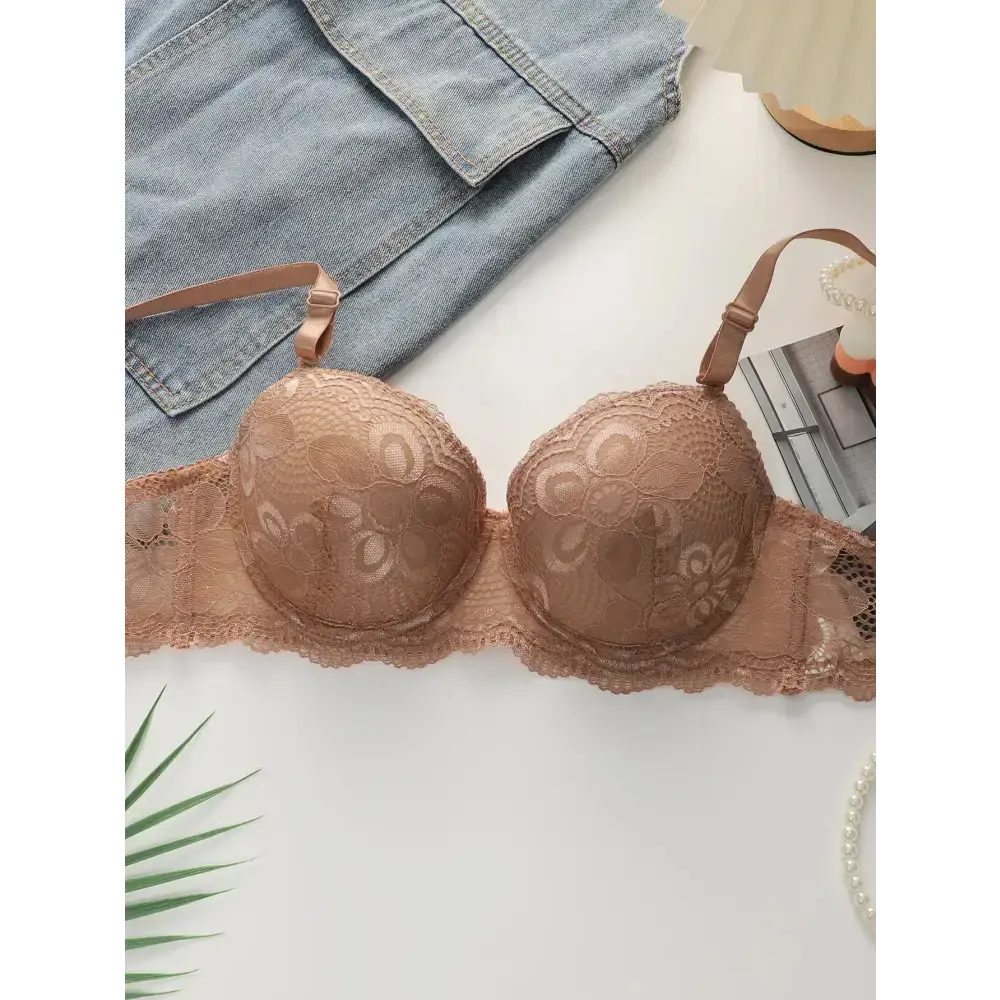 The Lady's Haven Boutique beige lace bra from 2-piece underwear set laid on white surface with denim and accessories