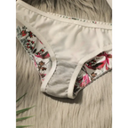 Close fitting floral bra and panty set panty with white fabric and colorful floral patterns
