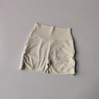 Beige drawstring sports shorts for women featuring a comfortable fit and stylish design