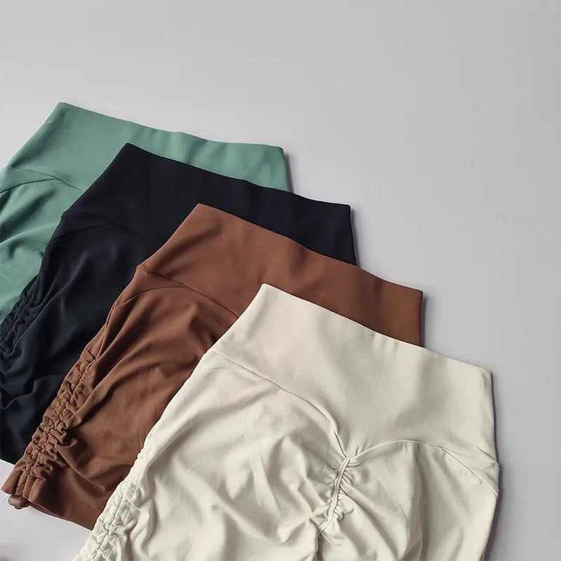 Colorful drawstring sports shorts for women in green, black, brown, and white fabric with adjustable waistbands