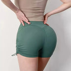 Green drawstring sports shorts for women with a flattering fit and adjustable sides for comfort