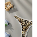 Leopard print lace underwear with white lace trim displayed on gray surface with decorative flowers
