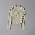 Long sleeve yoga crop tops for women in light beige with textured fabric and asymmetrical hem