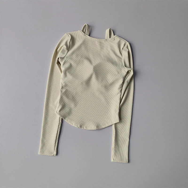 Long sleeve yoga crop tops for women in light beige with textured fabric and asymmetrical hem