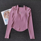 Light pink long sleeve yoga crop tops for women with button detail and soft ribbed fabric