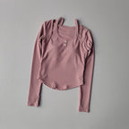 Pink long sleeve yoga crop tops for women featuring a textured fabric and button accents
