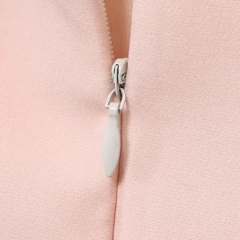 Close-up of zipper detail on pink casual cocktail dress fabric