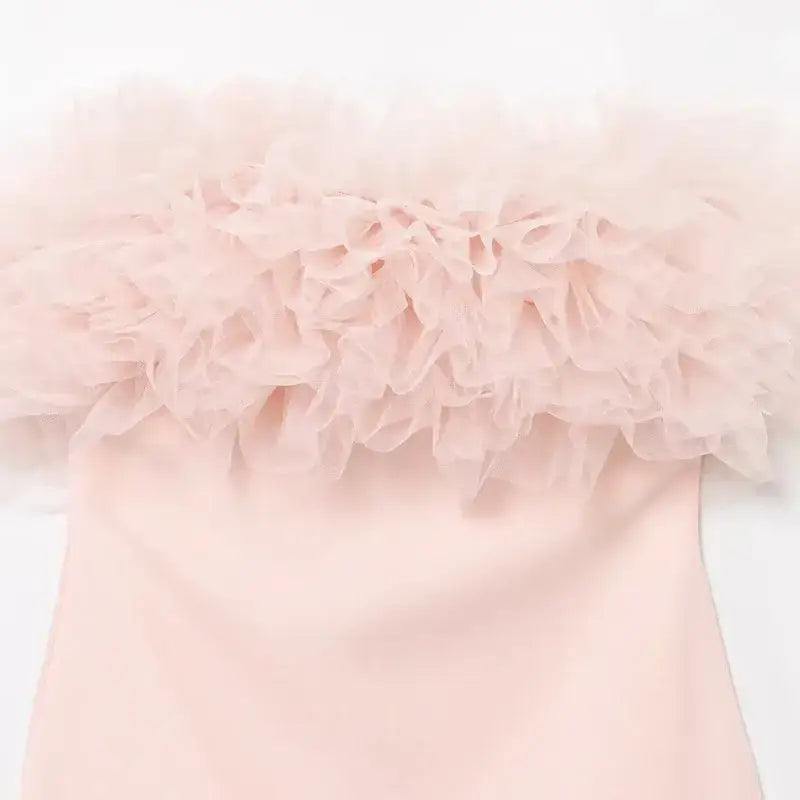 Close-up of a pink casual cocktail dress with soft ruffled tulle detailing on the top from The Lady's Haven Boutique