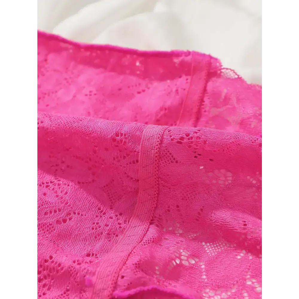 Close-up view of pink lace bralette and panties set showcasing delicate lace fabric details