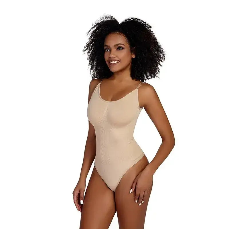 The Lady's Haven Boutique ribbed thong bodysuit shapewear in nude worn by smiling woman with curly hair