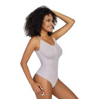 Smiling woman wearing a light gray ribbed thong bodysuit shapewear with adjustable straps