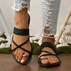 The Lady's Haven Boutique Rome style ring toe flat sandals in black braided design worn with ripped jeans