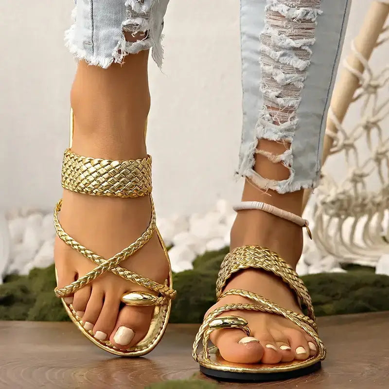 Rome style ring toe flat sandals in gold braided design worn with ripped white jeans from The Lady's Haven Boutique