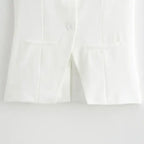 Close up of white tailored vest with pockets from summer office vest and shorts outfit by The Lady's Haven Boutique