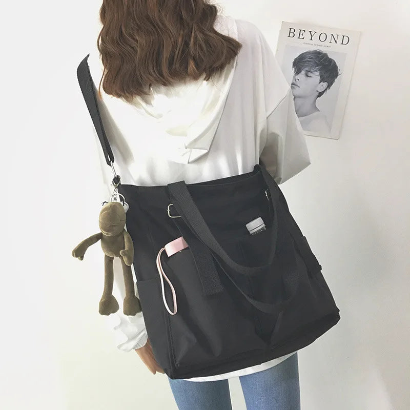 Stylish waterproof ladies handbag in black with adjustable strap and keychain accessory