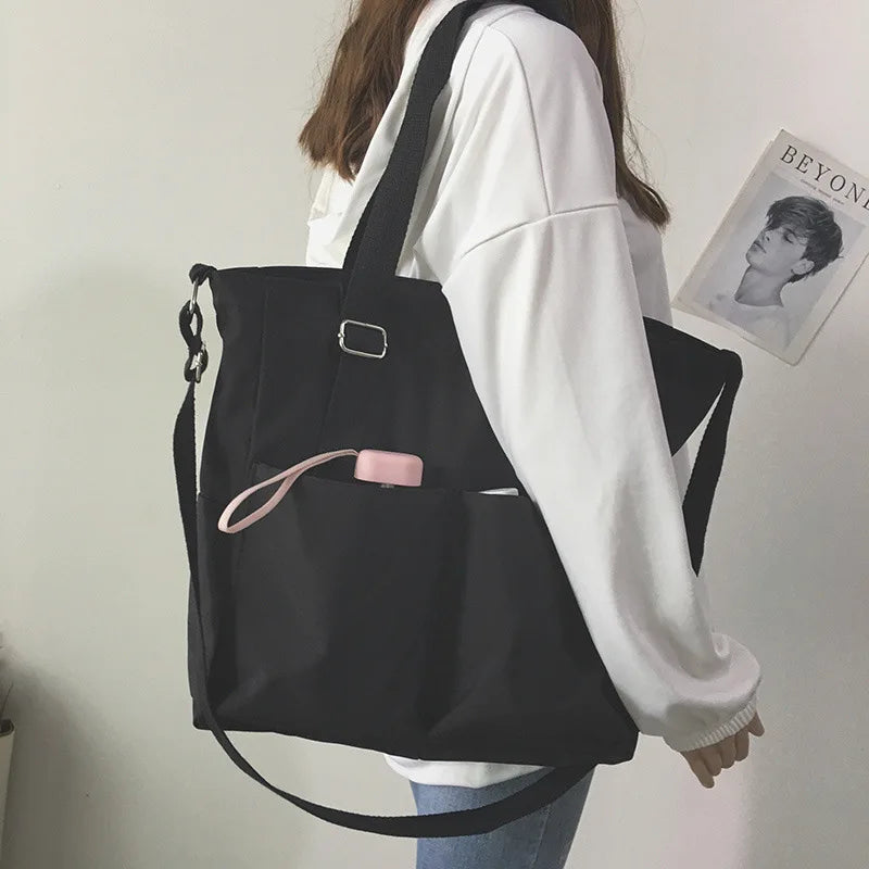 Stylish black waterproof ladies handbag with adjustable shoulder strap and side pocket