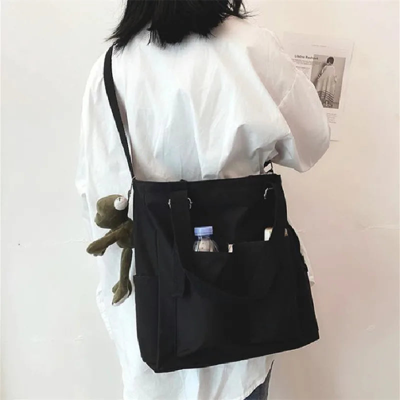 Stylish black waterproof ladies handbag with multiple pockets and adjustable strap for everyday use