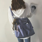 Stylish waterproof ladies handbag in lavender with multiple pockets and a cute keychain accessory