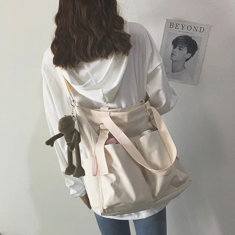 Stylish waterproof ladies handbag with multiple pockets and a cute charm for everyday use