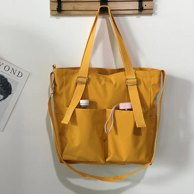 Bright yellow waterproof ladies handbag with adjustable straps and exterior pockets