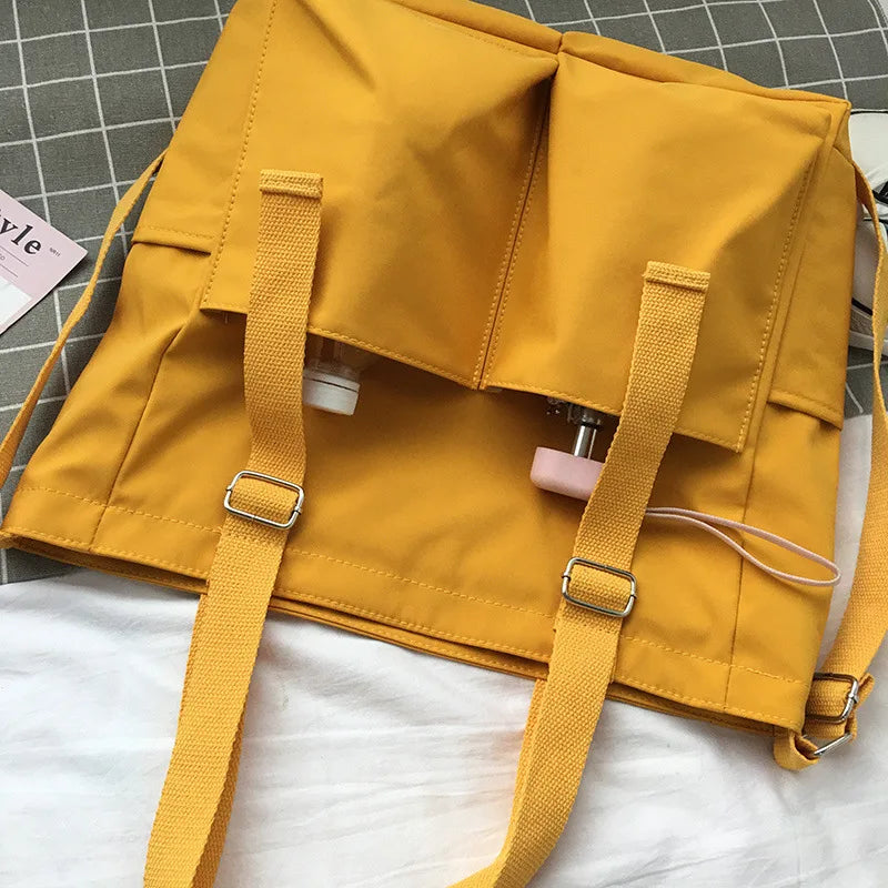 Stylish yellow waterproof ladies handbag featuring adjustable straps and multiple pockets