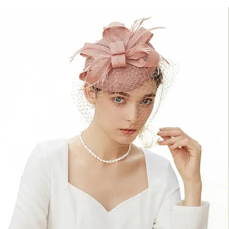 Elegant wedding pillbox hat with delicate netting and floral accent, perfect for special occasions