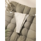 White seamless thong underwear with clear adjustable straps lying on a tufted gray cushion