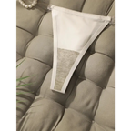 White seamless thong underwear from The Lady's Haven Boutique displayed on a cushioned surface