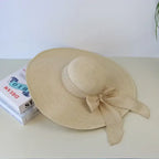 Wide brim floppy hat for women in natural color with a stylish bow, perfect for sunny days