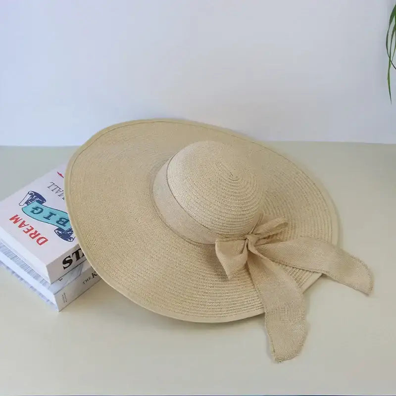 Wide brim floppy hat for women in natural color with a stylish bow, perfect for sunny days