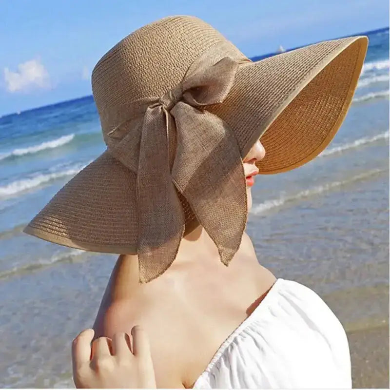 Wide brim floppy hat for women with a stylish bow, perfect for beach outings