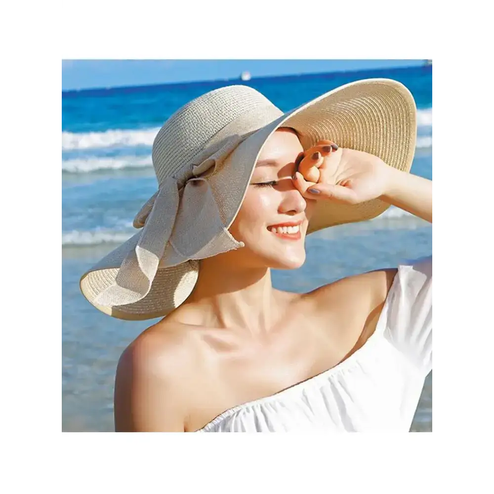 Wide brim floppy hat for women, cream color with a stylish bow, perfect for beach days