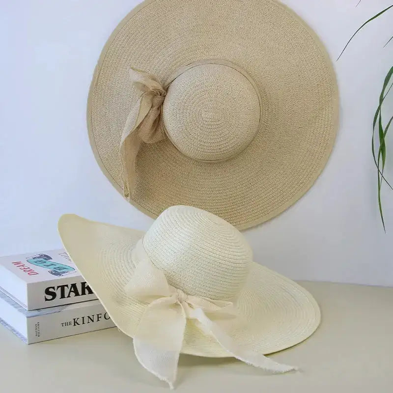 Two elegant wide brim floppy hats for women in beige with ribbon detail on top