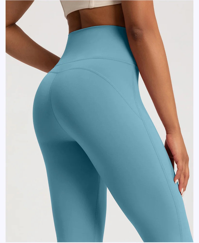 Side view of a woman wearing wide leg sports leggings in blue for activewear enthusiasts